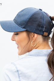 Woman wearing a blue denim cap with a blurred background