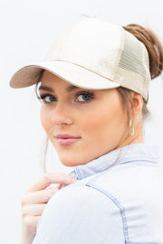 Woman wearing a beige cap with a white background