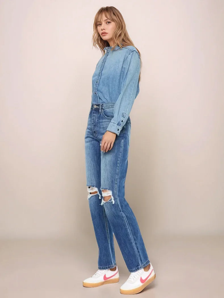 Woman wearing a denim outfit with a beige background