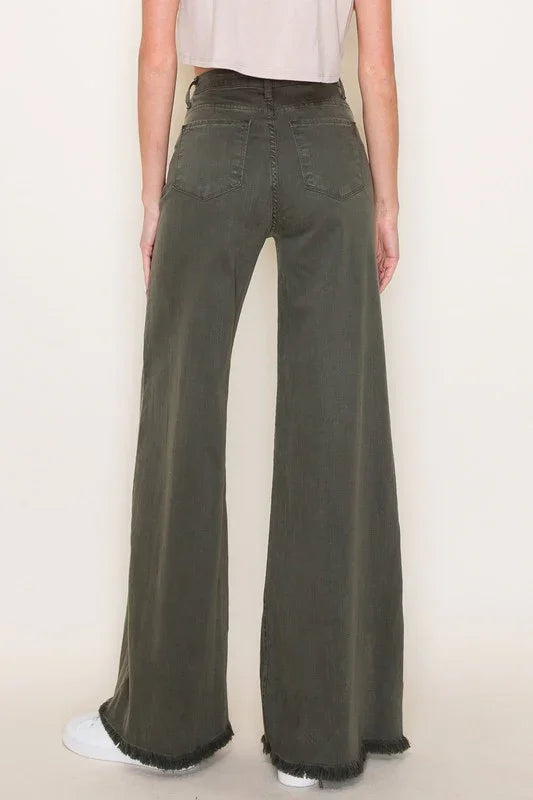 Person wearing olive green wide-leg jeans against a plain background