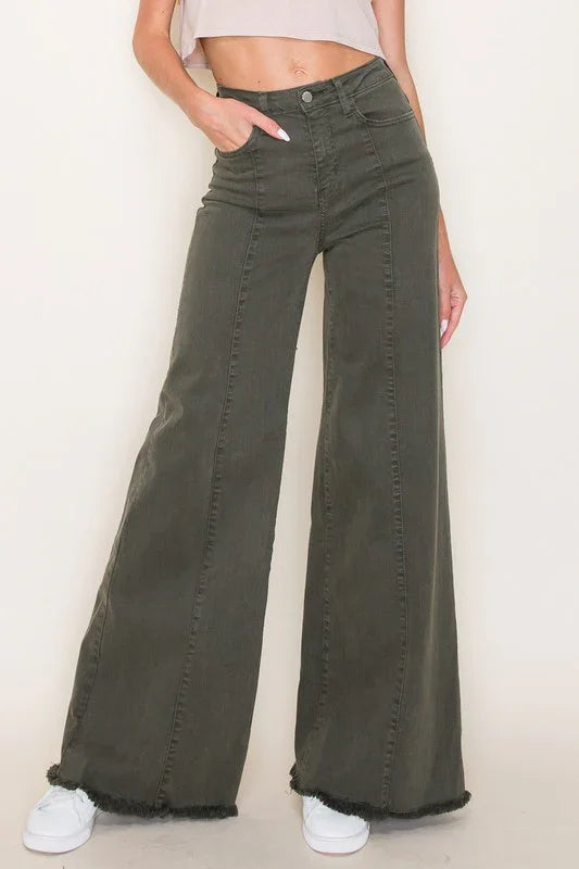 Person wearing olive green wide-leg jeans against a plain background