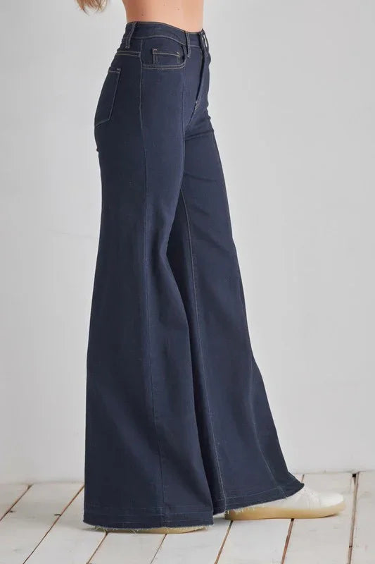 Navy blue wide-leg jeans on a white background