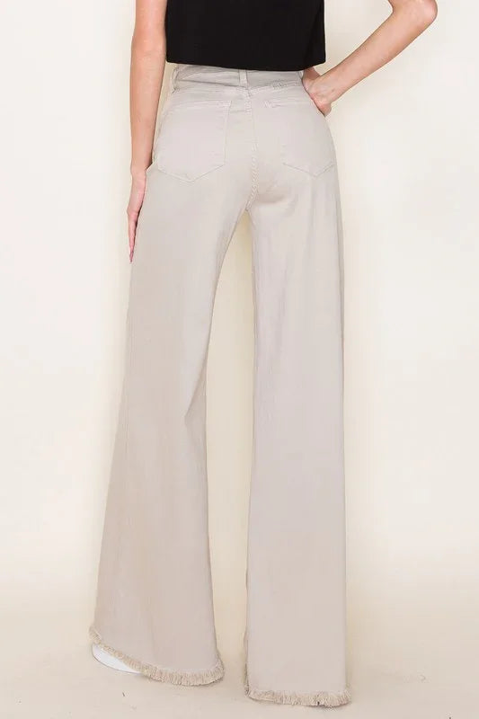Light khaki wide-leg pants worn by a person on a plain background