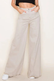 Beige wide-leg pants worn by a person on a plain background