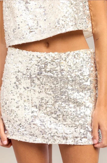 a persn wearing an ivory skirt and matching top