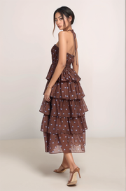 Angled back view of the Maren backless halter midi dress featuring the adjustable tie neckline and smocked back panel.