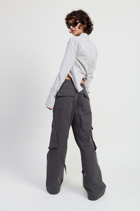 Person wearing a light gray striped shirt and dark gray cargo pants on a white background