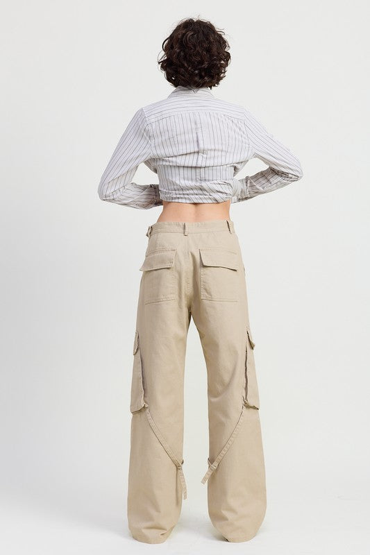 Person wearing a striped shirt and beige cargo pants on a white background