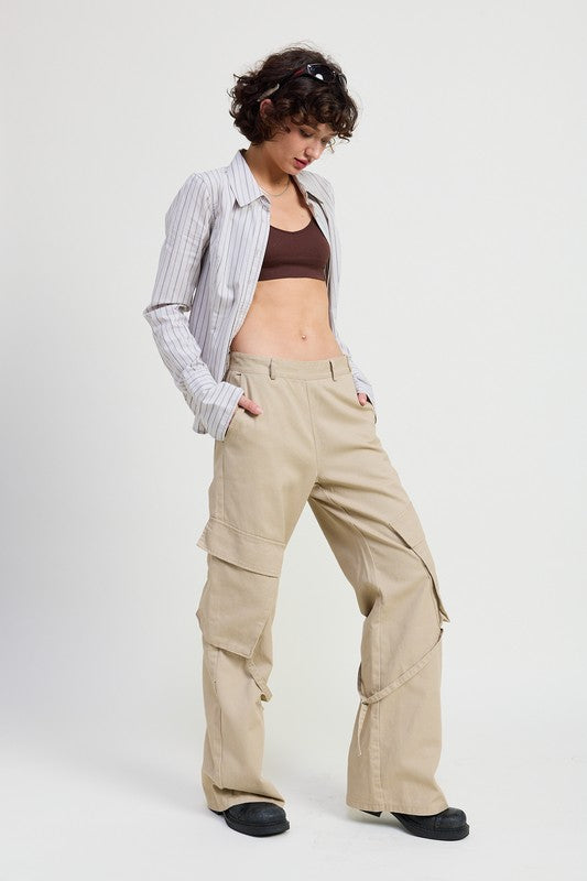 Person wearing beige cargo pants on a white background