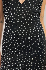 Black dress with silver bead pattern worn by a person
