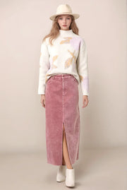 woman wearing a floral sweater and a long skirt