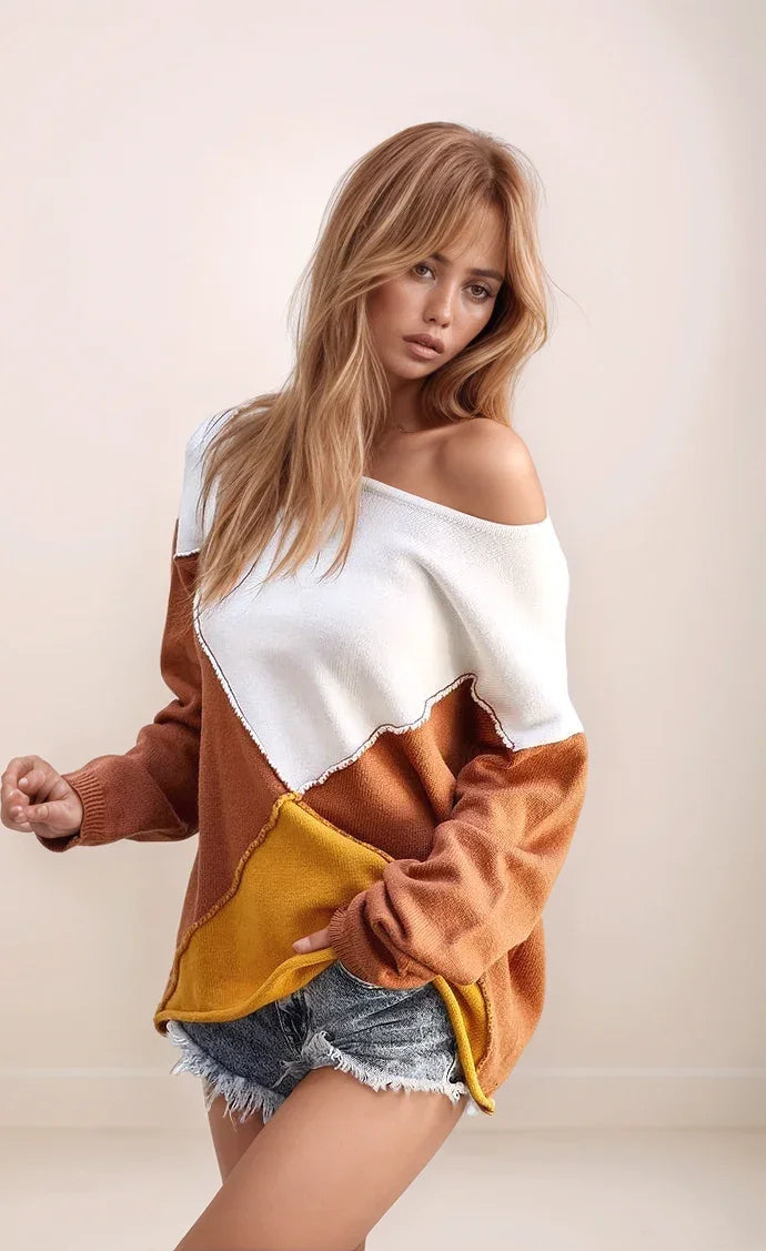 Woman wearing a color-blocked sweater with white, brown, and yellow sections on a plain background.