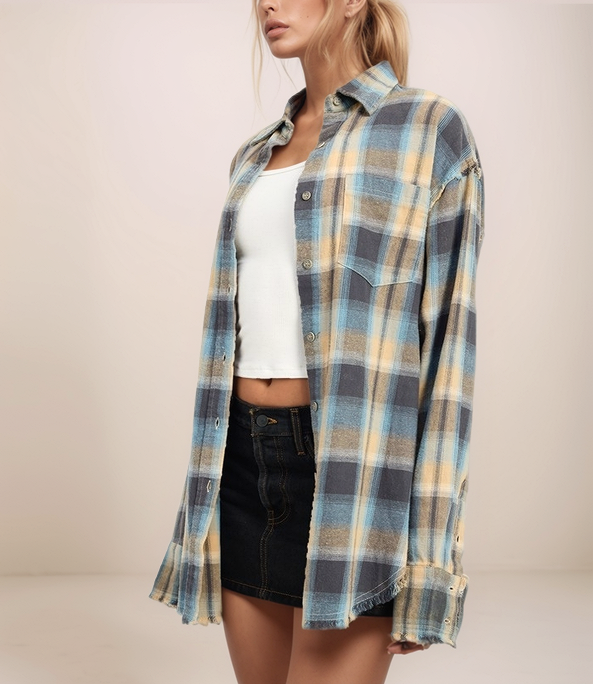 Person wearing a plaid shirt over a white top and black shorts on a plain background