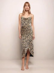 Woman wearing a tiger print dress against a plain background