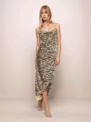 Woman wearing a tiger print dress against a plain background