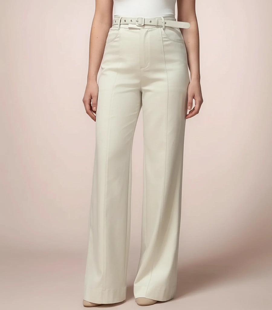 Person wearing white wide-leg pants on a pink background