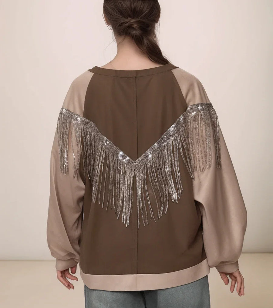 Brown and beige jacket with fringe details on a plain background