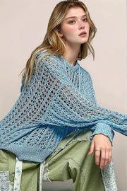 A detailed, angled lifestyle shot of the POL Skye sweater, highlighting the sculptural quality of the knit and its slightly transparent, layering-friendly finish.