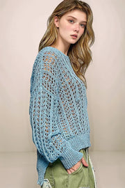Side profile of the light blue POL Skye sweater, showcasing the long sleeves, side-vent openings at the hem, and the modern high-low silhouette.