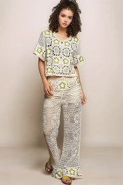 Full-body view of a model wearing the cream Stardust Cardigan paired with the matching wide-leg crochet pants, showcasing a coordinated, head-to-toe celestial look.