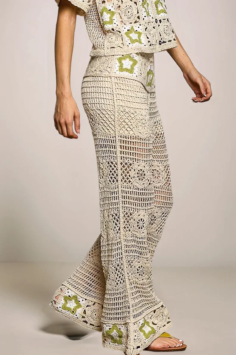 Side profile of the Stardust Star Crochet Pants, emphasizing the dramatic flared hem and the vertical lattice stitch patterns that elongate the silhouette.