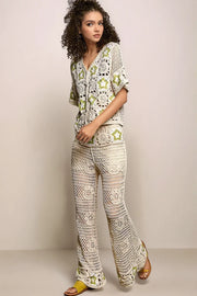 Full-body view of a model wearing the cream Stardust Pants paired with the matching crocheted cardigan showcasing a coordinated, head-to-toe celestial look.