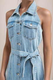 Close-up of cotton denim halter dress with button-front detail and chest pockets
