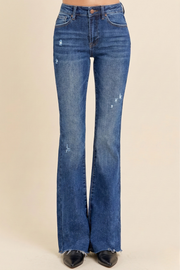 Distressed mid-rise flare jeans with raw hem and vintage-inspired flare leg