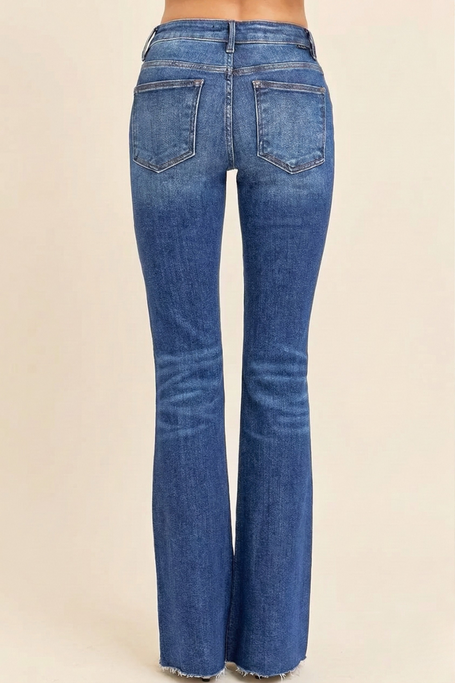 Back view of distressed mid-rise flare jeans with vintage flare silhouette