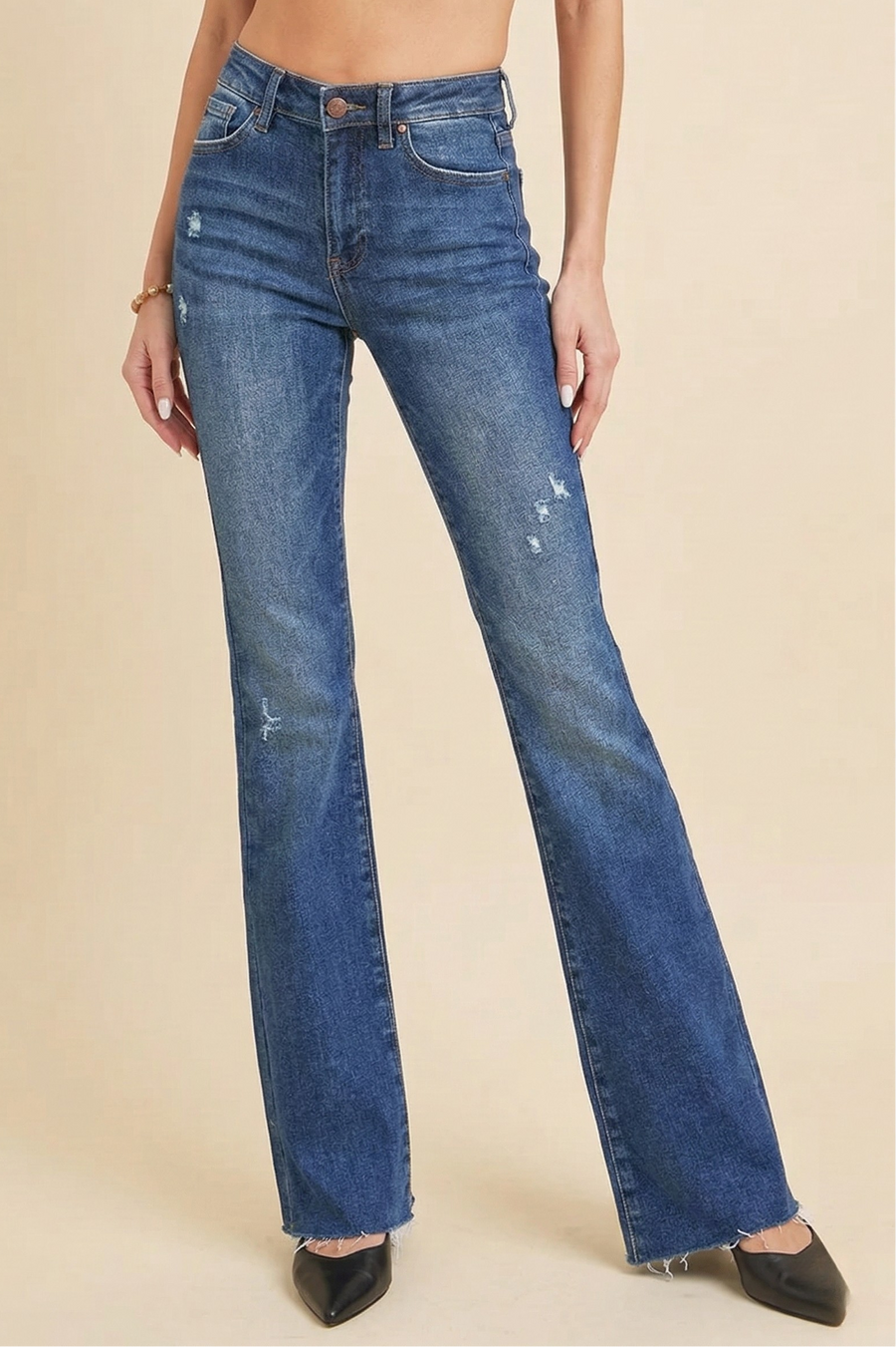 Distressed mid-rise flare jeans with raw hem and vintage-inspired flare leg