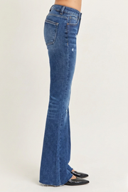 Women's lightly distressed mid-rise flare jeans with raw hem and slight stretch