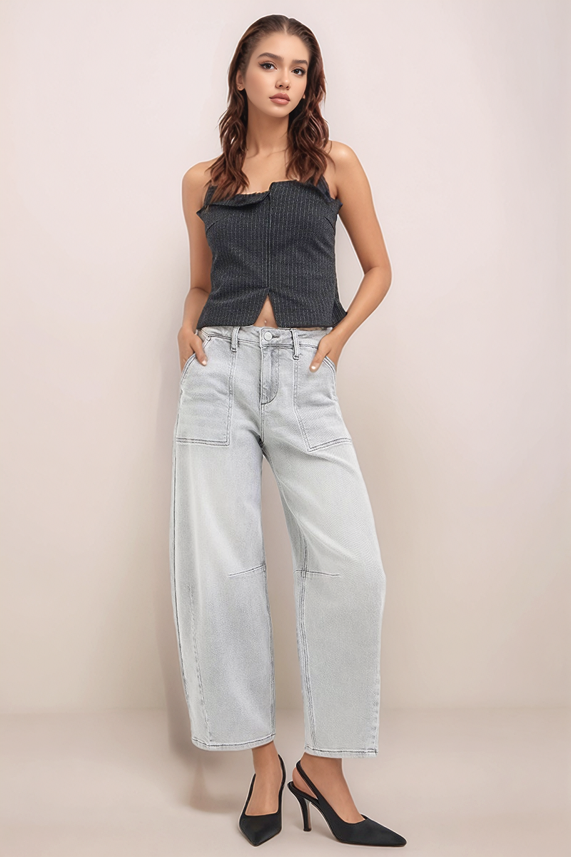 Model wearing RISEN light wash slouchy cropped barrel jeans with front patch pockets and cropped barrel-leg silhouette