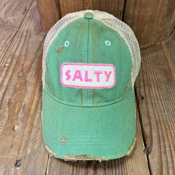 Green cap with 'Salty' patch on a wooden surface