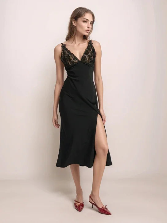 a woman wearing a black slip dress and red shoes