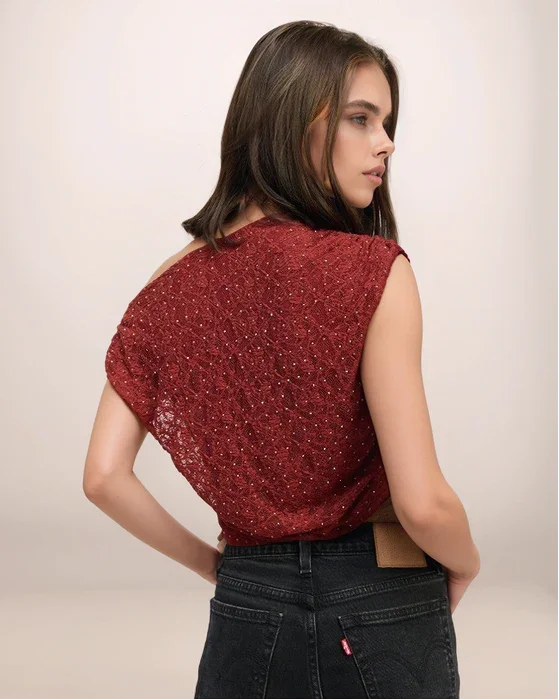 Woman wearing a red sleeveless top with a plain background