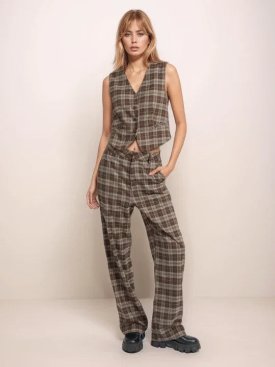 Woman wearing a plaid vest and pants against a white background
