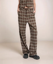 Plaid pants worn by a person on a beige background