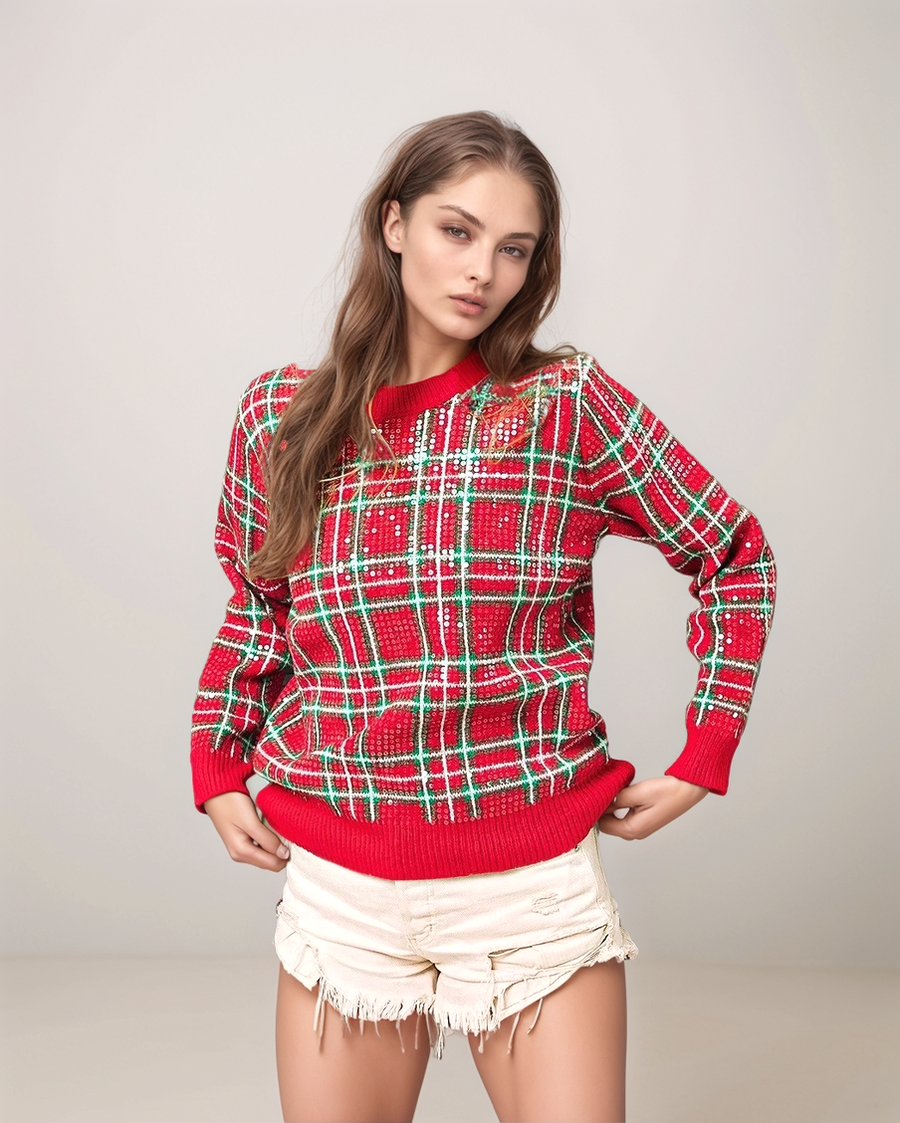 Woman wearing a red and green plaid sweater with white shorts on a light gray background