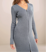 Woman wearing a ribbed knit dress against a beige background