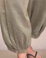 leg detail on faded charcoal sweatpants that features a cropped gathered hem with a button closure
