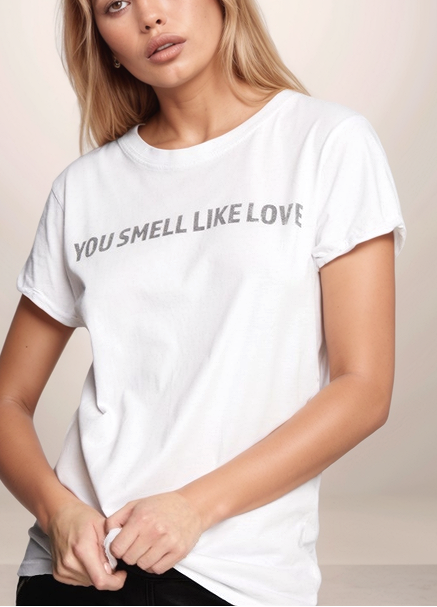 Woman wearing a white t-shirt with text on a plain background